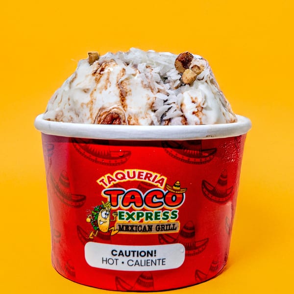 Taqueria Taco Express ice cream cup with white ice cream, chocolate swirls, and nuts on a yellow background.